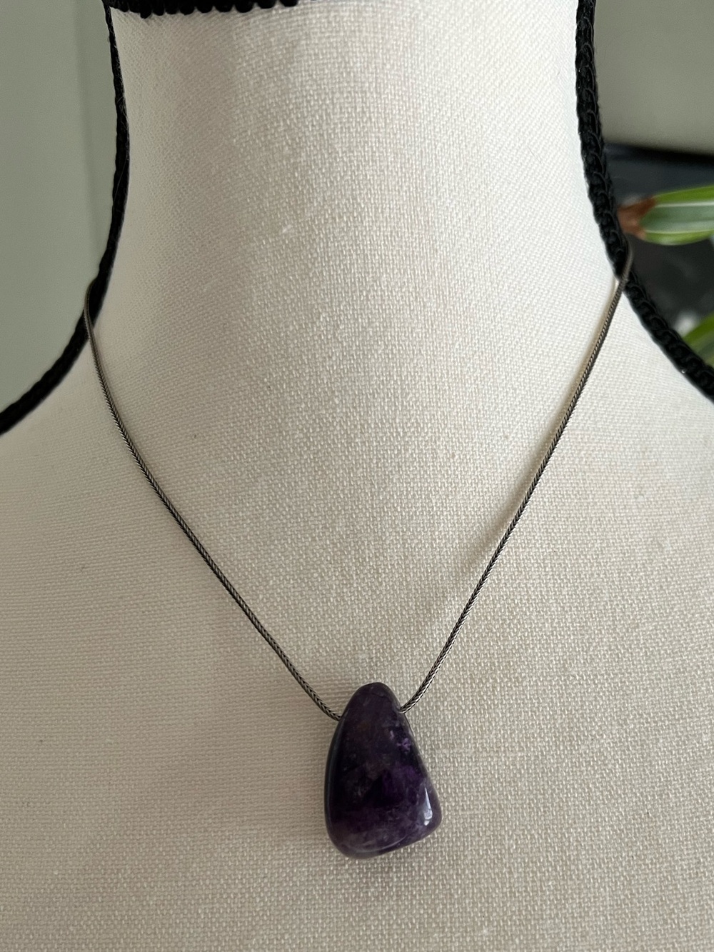 Polished amethyst teardrop shaped gemstone on a 925 snake chain necklace.